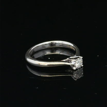 9ct white gold diamond solitaire ring by Reeves and Sons, featuring a sparkling central diamond on a sleek band.