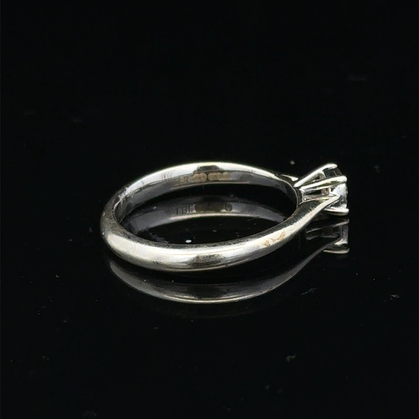 9ct white gold diamond solitaire ring by Reeves and Sons, featuring a sparkling central diamond on a sleek band.