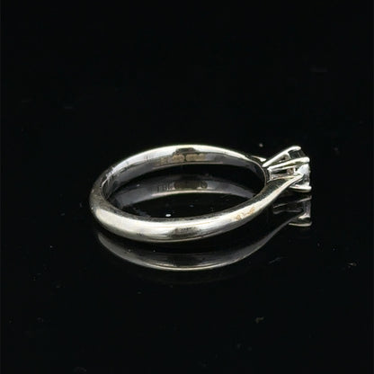 9ct white gold diamond solitaire ring by Reeves and Sons, featuring a sparkling central diamond on a sleek band.