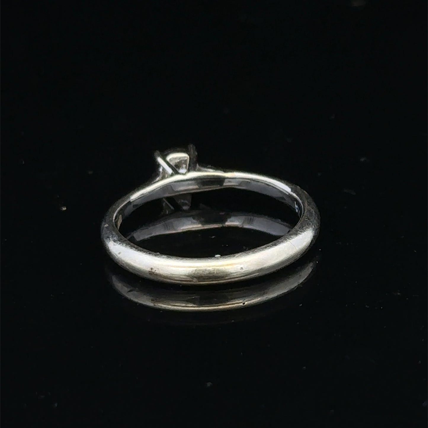 9ct white gold diamond solitaire ring by Reeves and Sons, featuring a sparkling central diamond and elegant design.