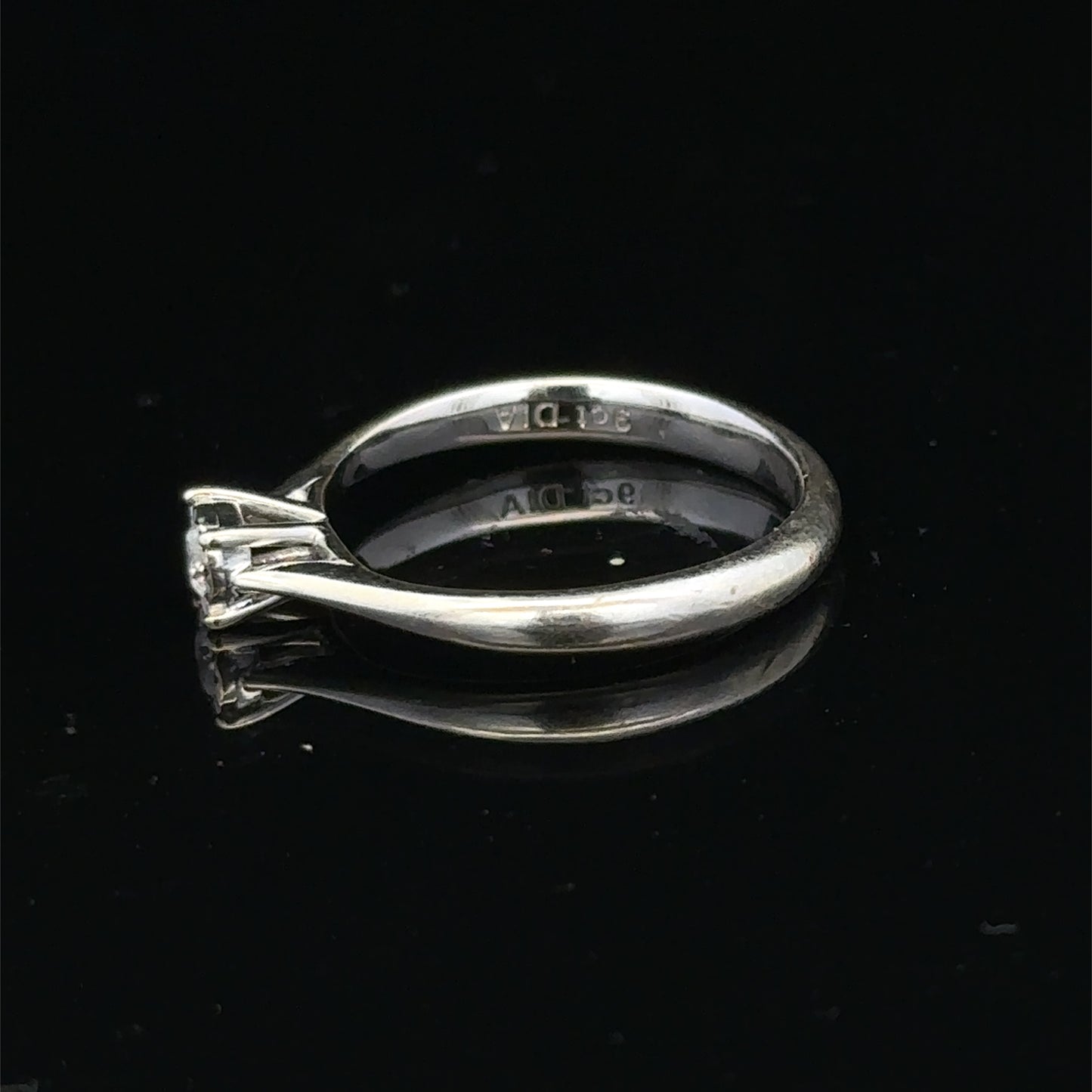 9ct white gold diamond solitaire ring by Reeves and Sons featuring a sparkling central diamond and elegant band.