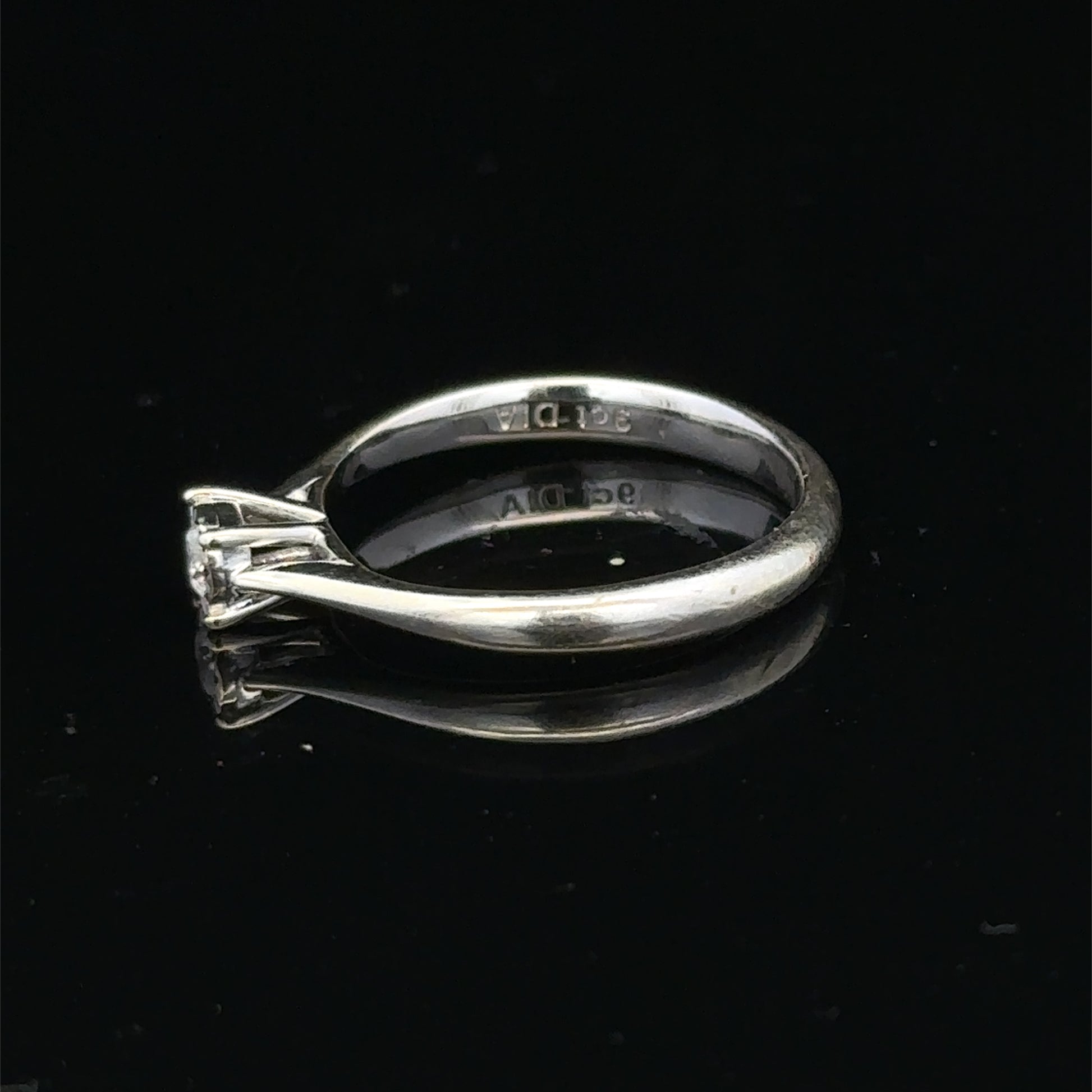9ct white gold diamond solitaire ring by Reeves and Sons featuring a sparkling central diamond and elegant band.