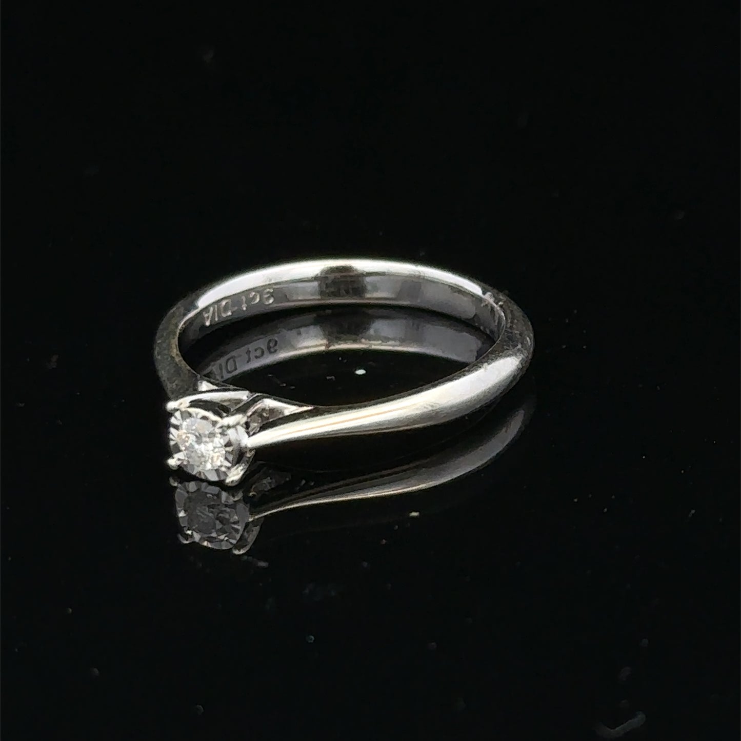 9ct white gold diamond solitaire ring by Reeves and Sons featuring a single sparkling diamond setting.