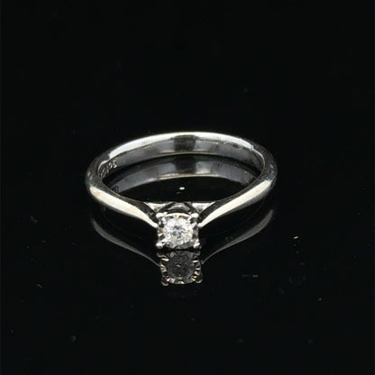 9ct white gold diamond solitaire ring by Reeves and Sons with a prominent central diamond and sleek band design.