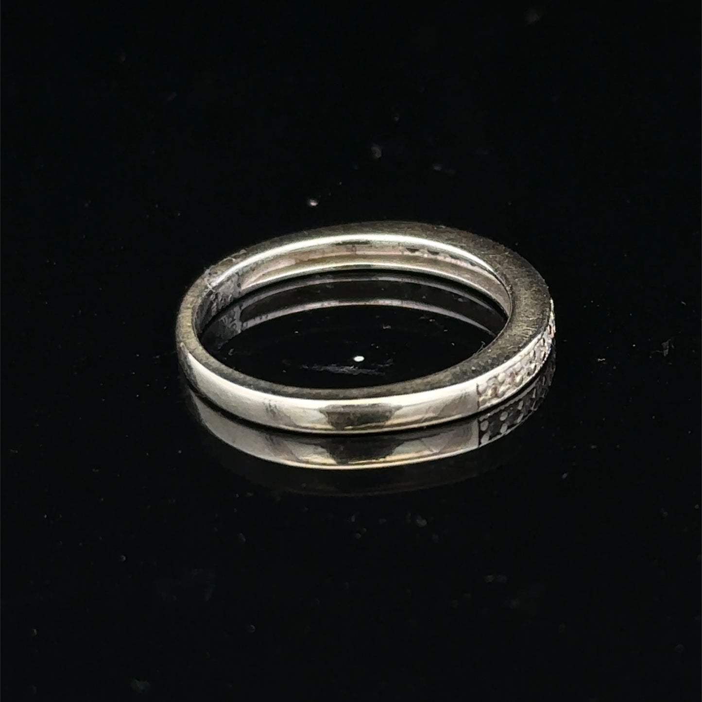 9ct white gold diamond half eternity ring with sparkling diamonds, crafted by Reeves and Sons, shown close-up.