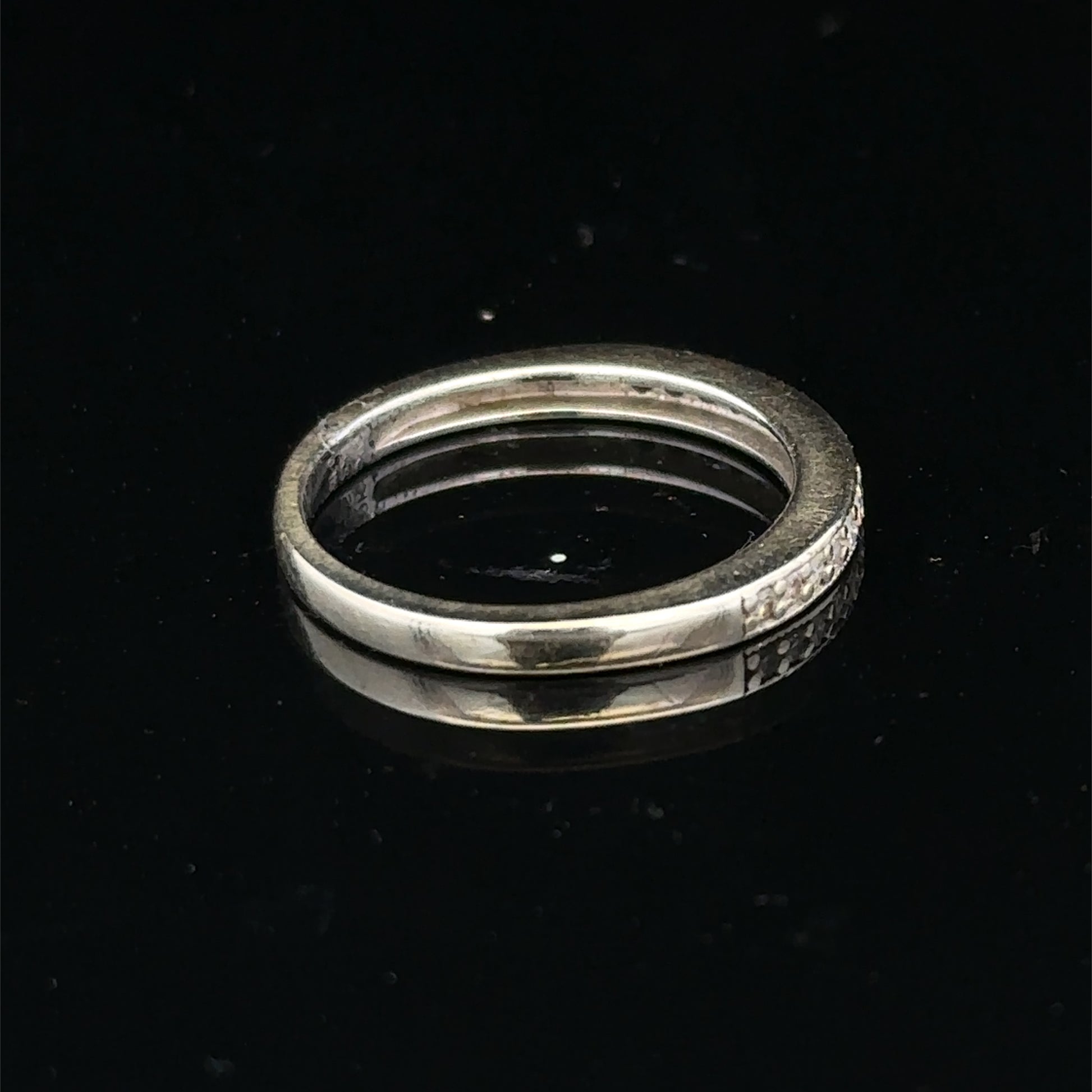 9ct white gold diamond half eternity ring with sparkling diamonds, crafted by Reeves and Sons, shown close-up.