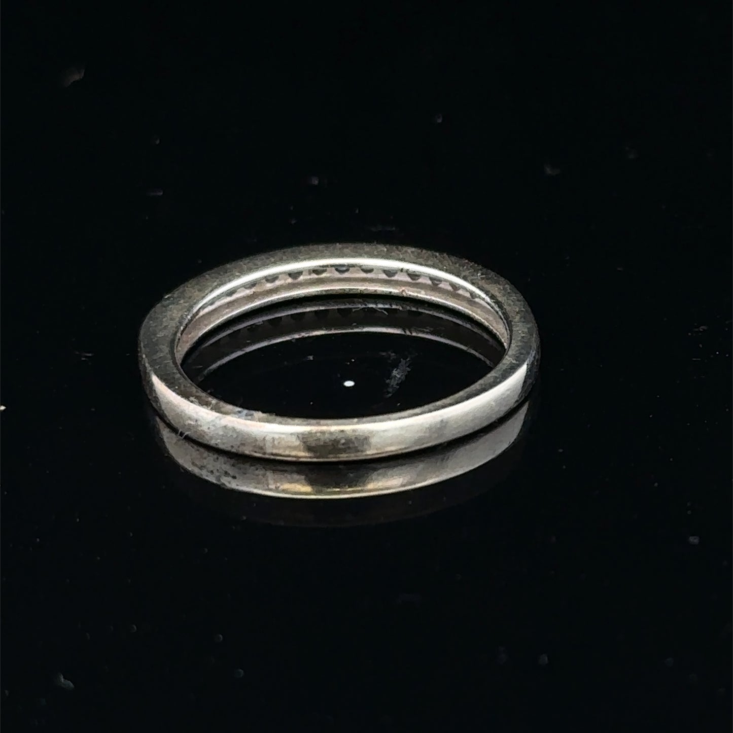 9ct white gold diamond half eternity ring featuring sparkling diamonds set in a sleek Reeves and Sons design.