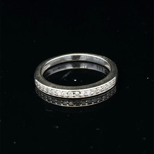 9ct white gold diamond half eternity ring with sparkling diamonds, crafted by Reeves and Sons, shown from a side angle.