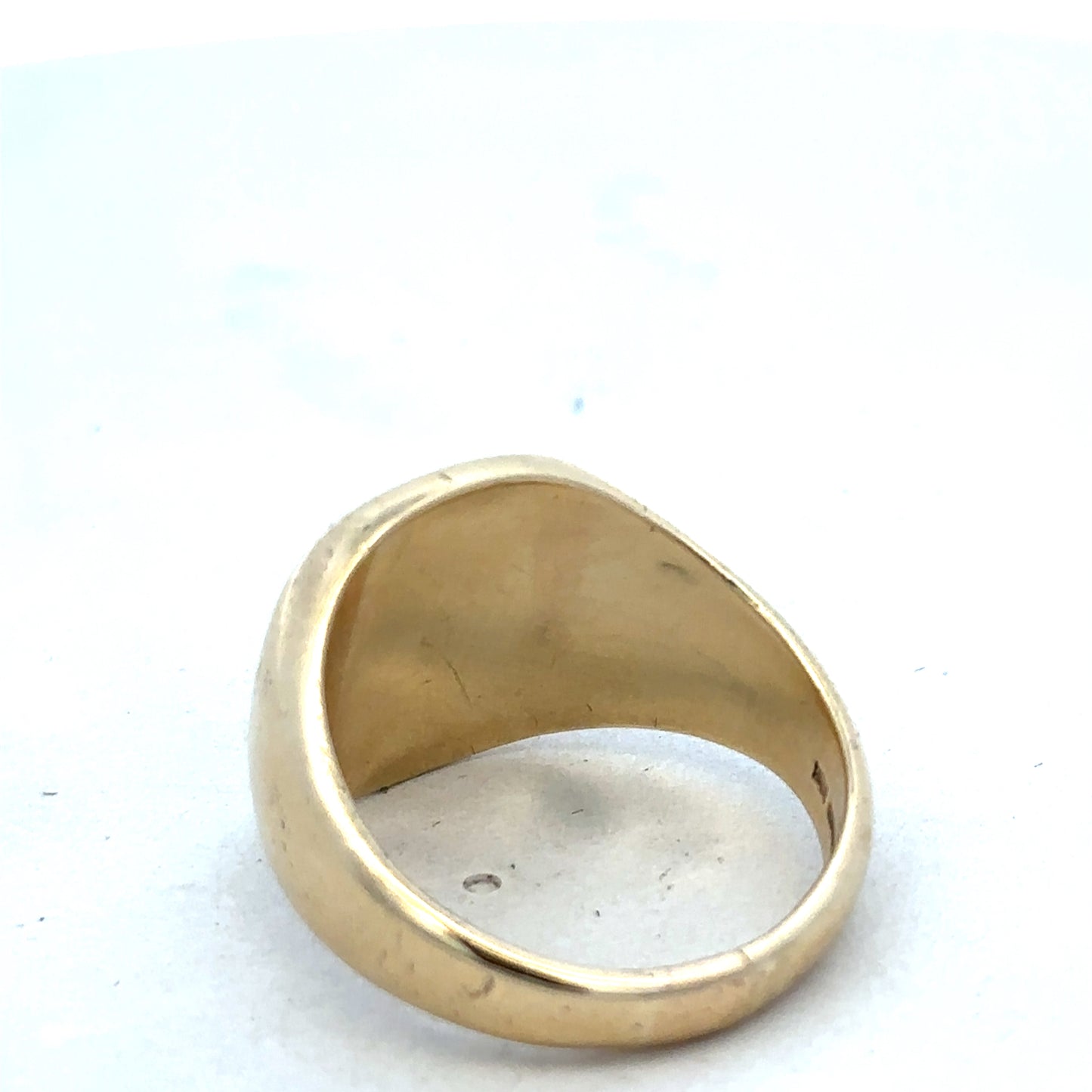 9ct yellow gold signet ring by Reeves and Sons, featuring a polished surface and classic design, shown on a neutral background.