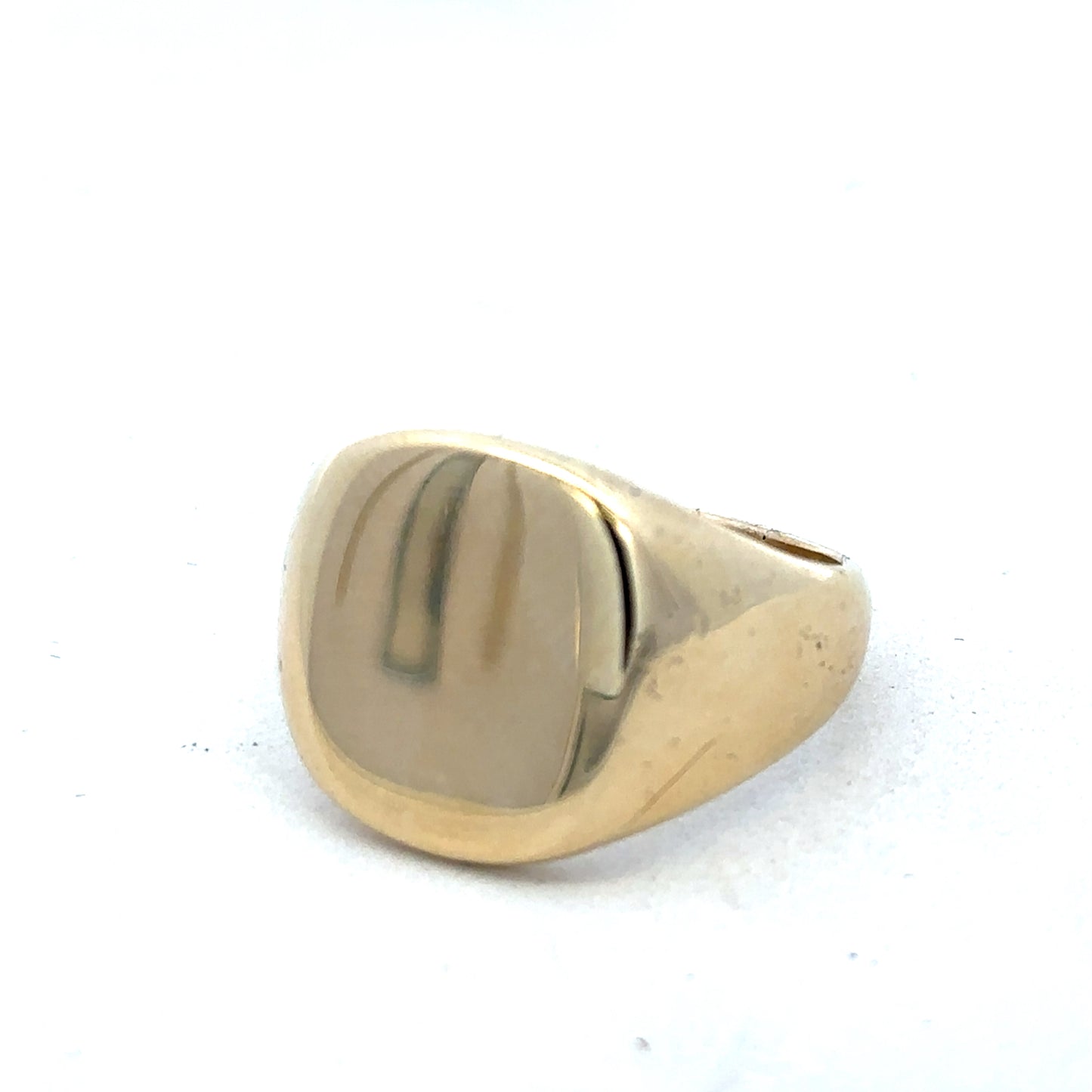 9ct yellow gold signet ring by Reeves and Sons, featuring a smooth polished surface and classic ring design.