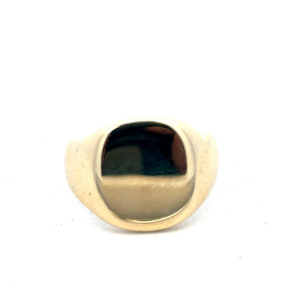 9ct yellow gold signet ring by Reeves and Sons, featuring a polished, classic design with a smooth surface and engraved details.