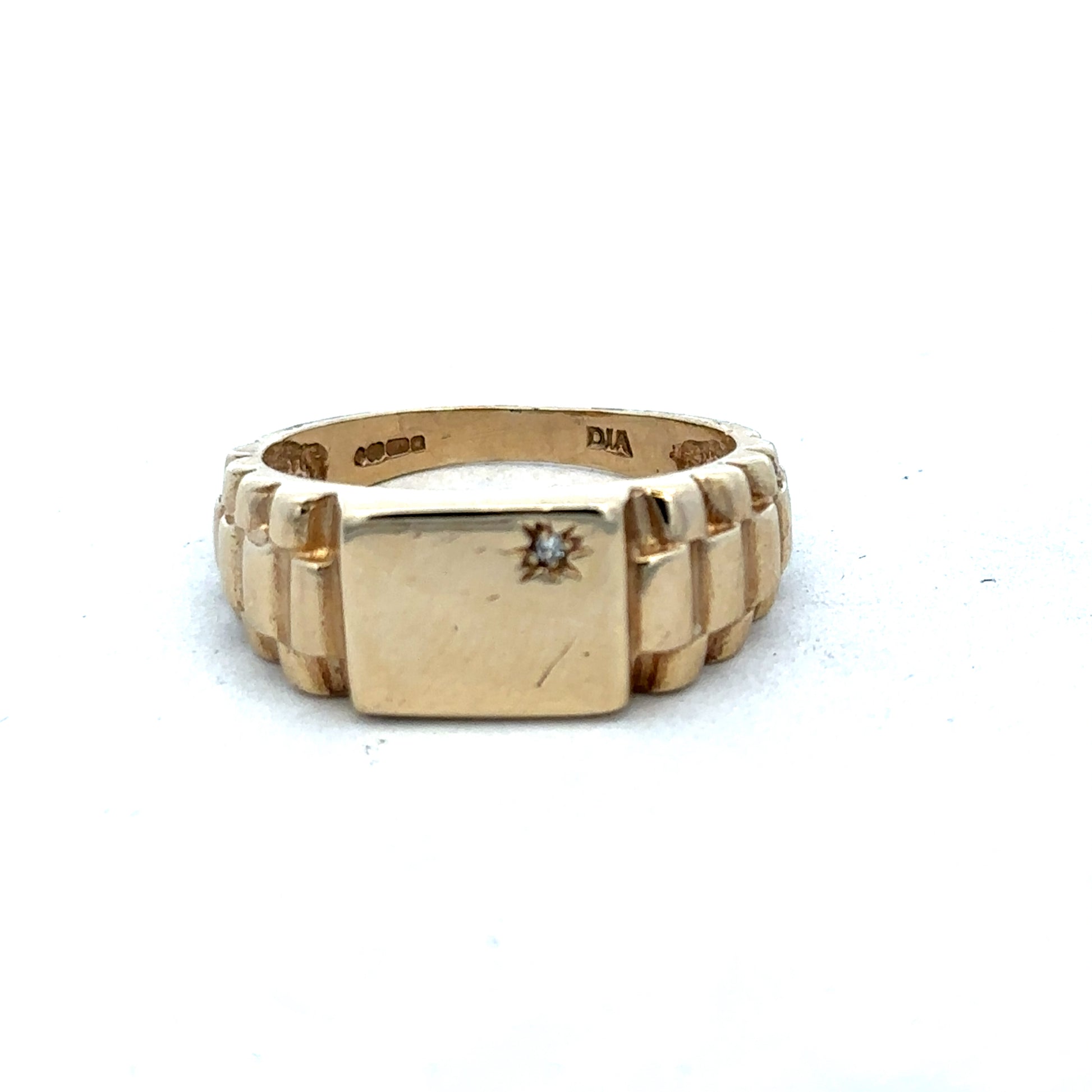 9ct yellow gold diamond ring by Reeves and Sons, featuring a sparkling diamond set in a polished gold band.