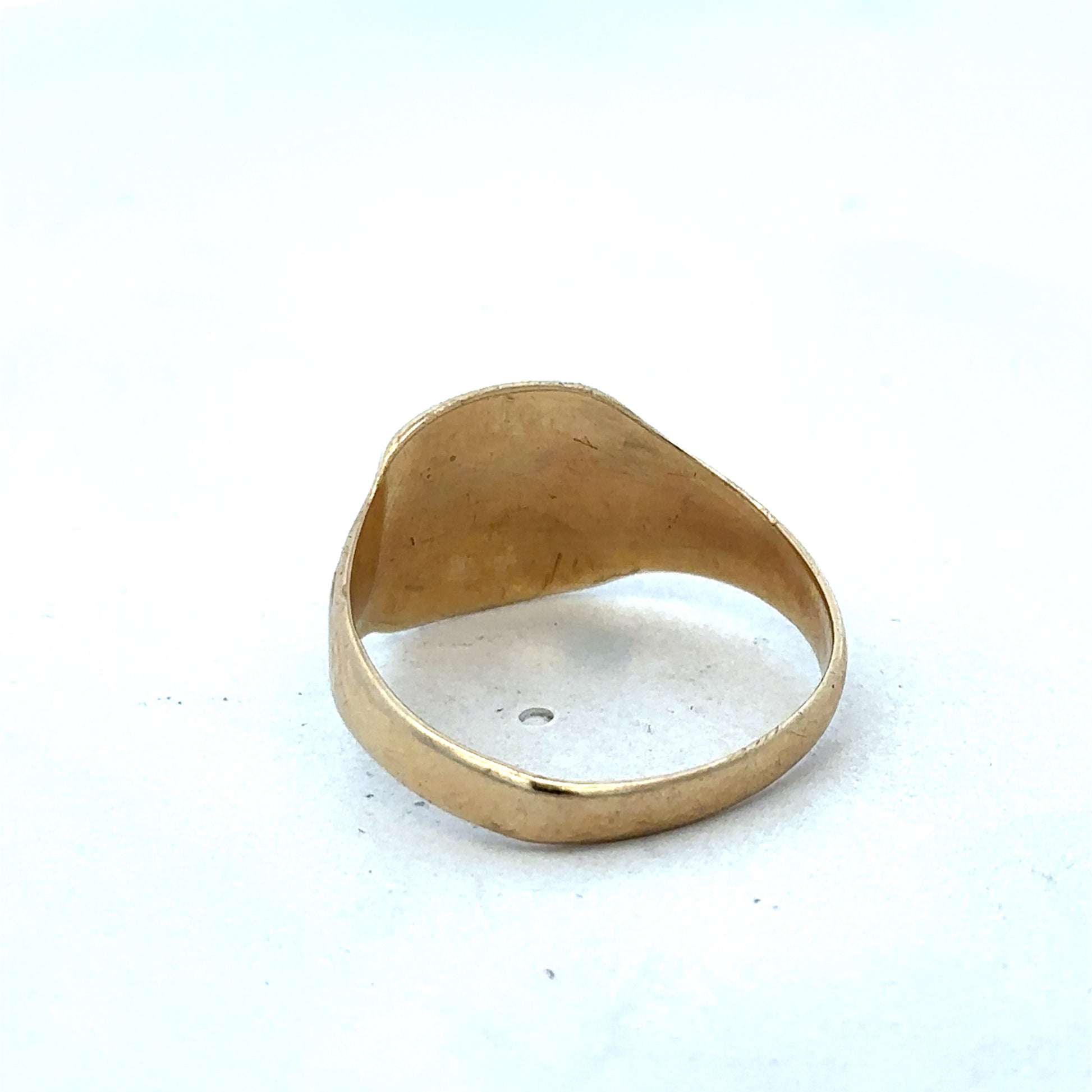 9ct yellow gold ring by Reeves and Sons featuring a classic design and polished finish, displayed on a plain background.