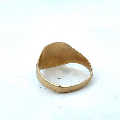 9ct yellow gold ring by Reeves and Sons featuring a classic design and polished finish, displayed on a plain background.