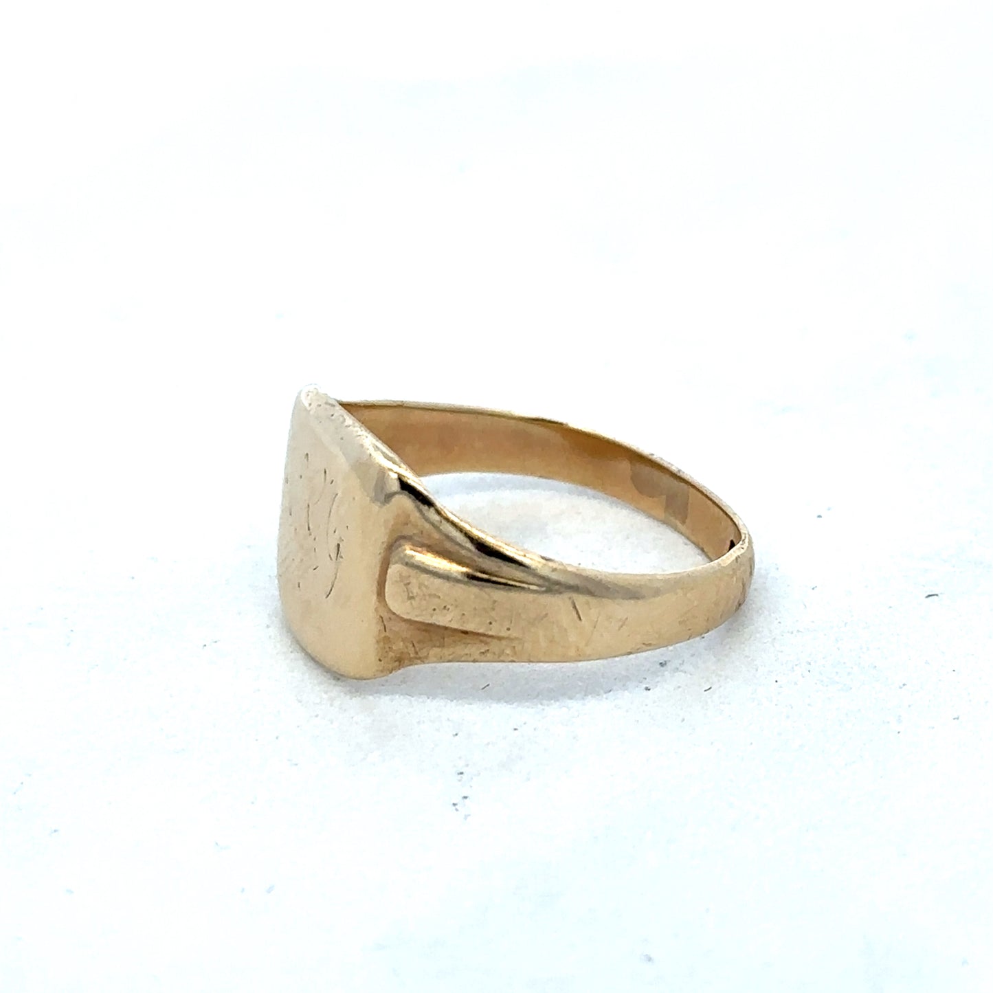 9ct yellow gold ring with simple band design, crafted by Reeves and Sons, shown in close-up on a white background.