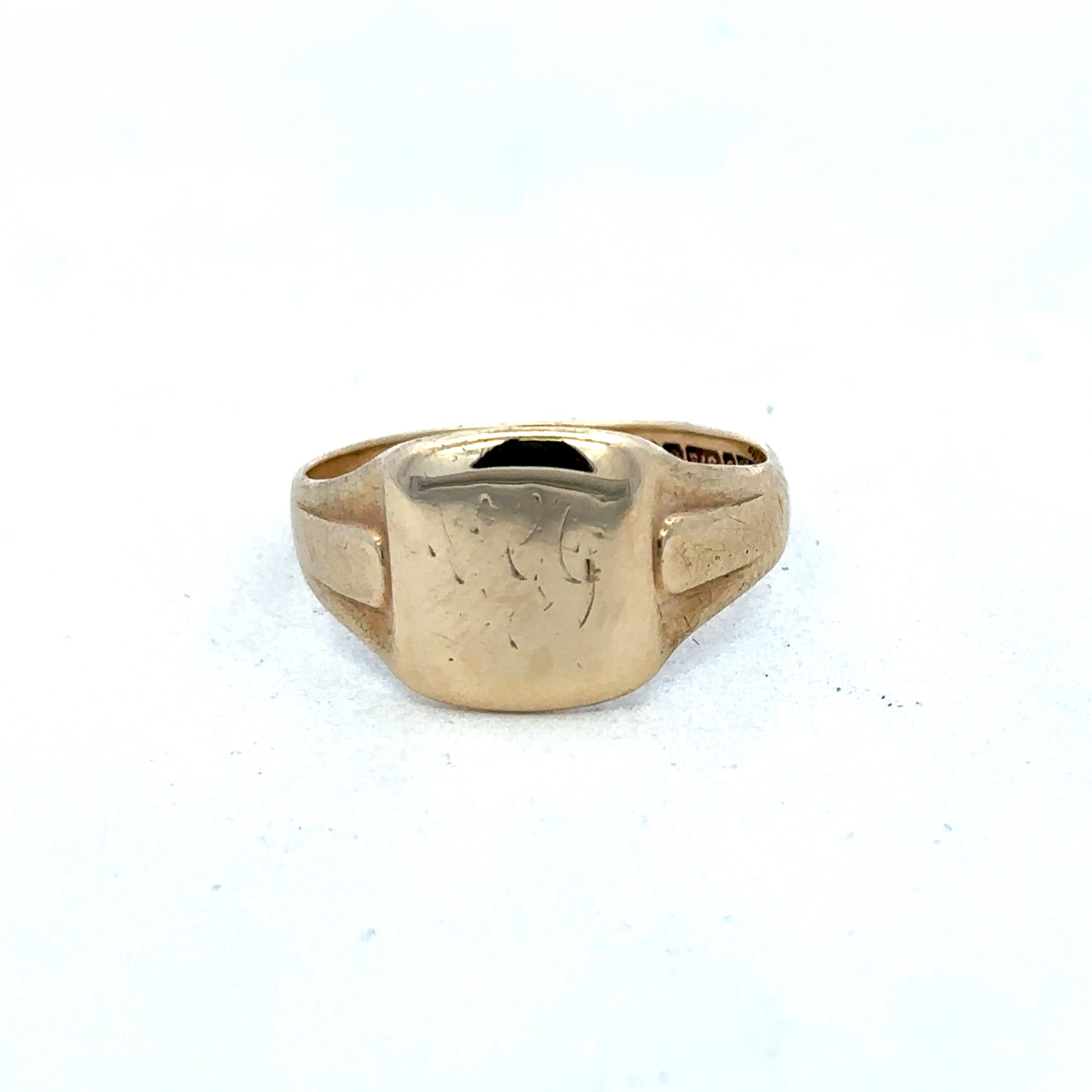 9ct yellow gold ring by Reeves and Sons, showcasing a sleek and polished band with a smooth finish.