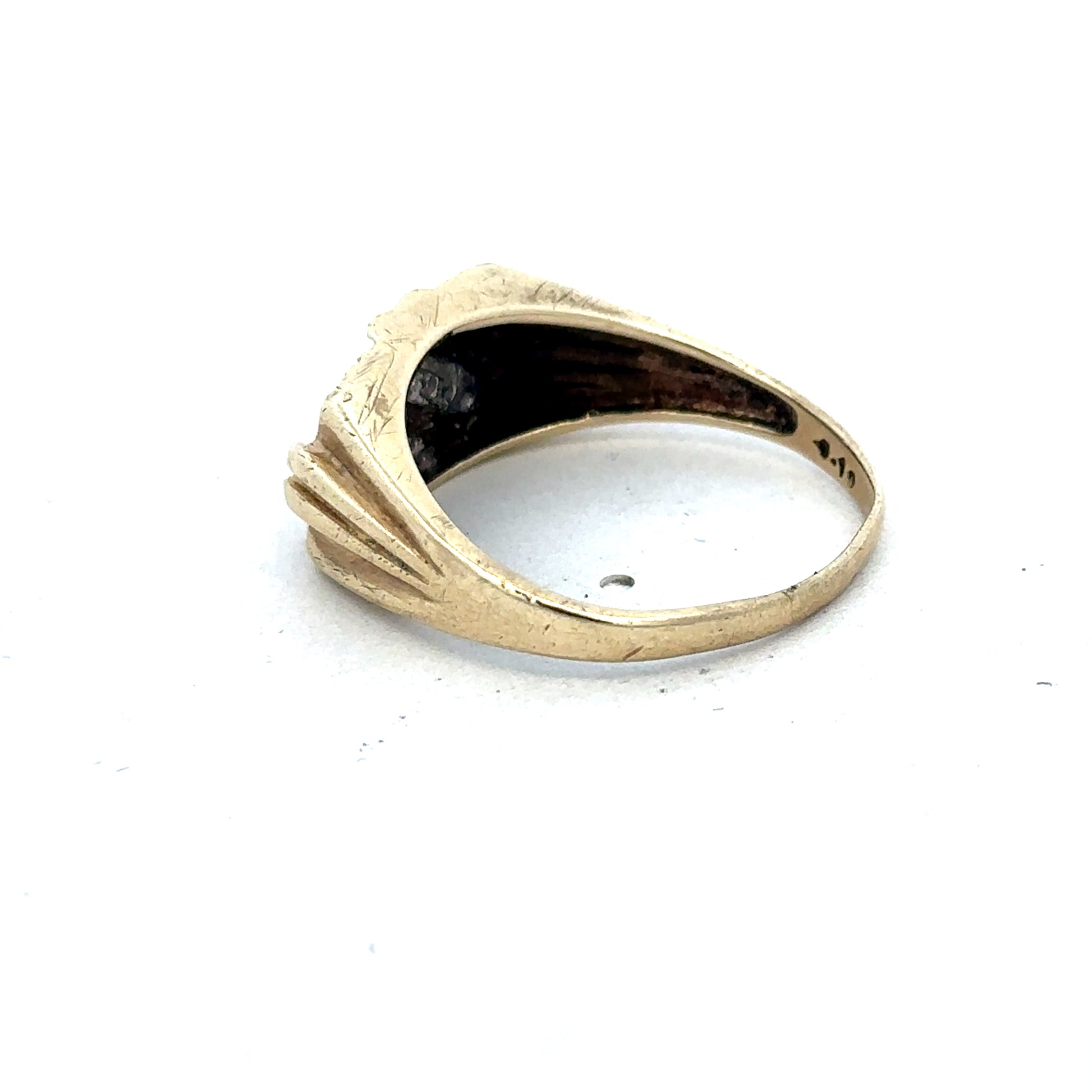 9ct yellow gold diamond ring by Reeves and Sons with sparkling diamonds and a polished band, shown close-up.