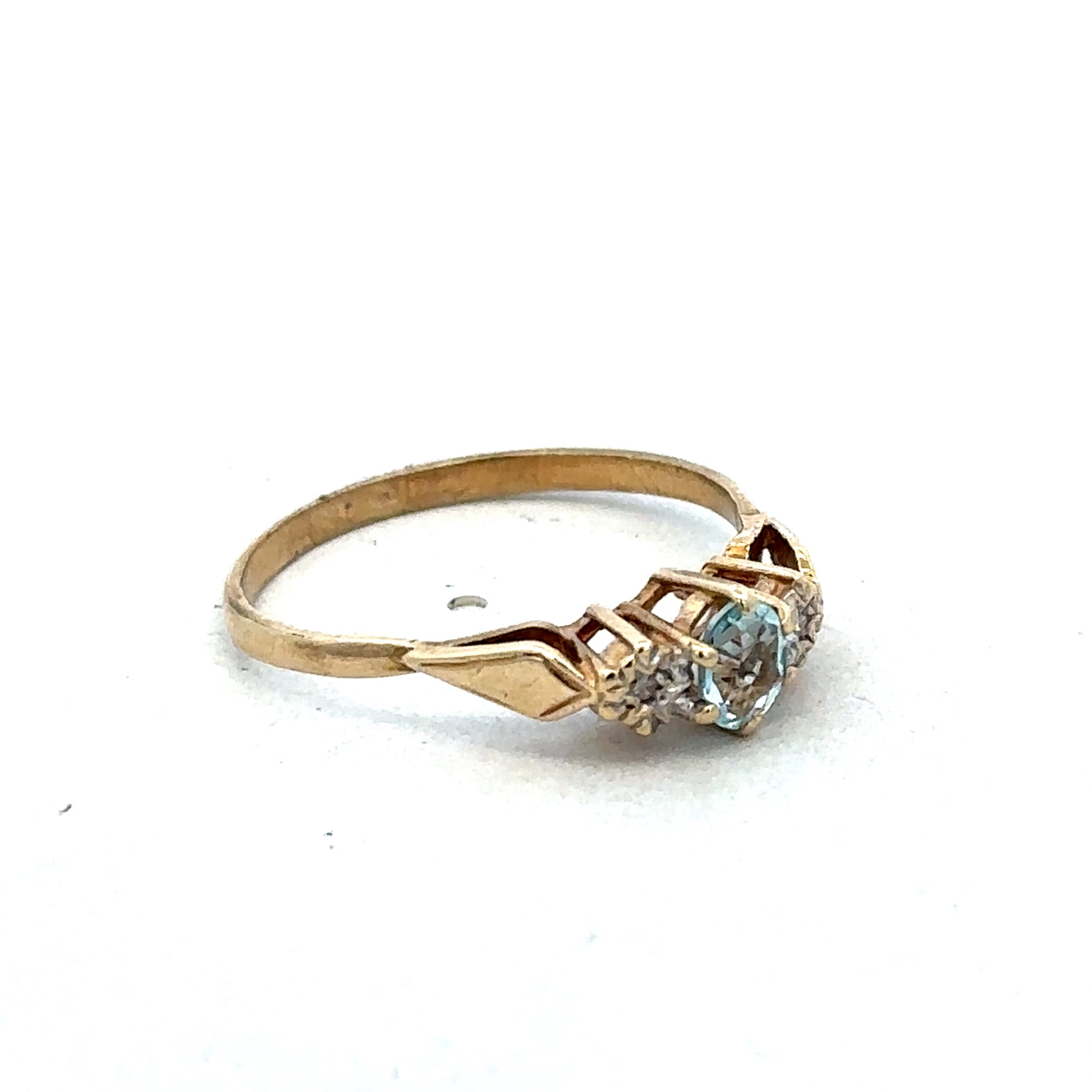 9ct yellow gold diamond ring by Reeves and Sons, featuring a detailed design and sparkling diamonds on a polished band.