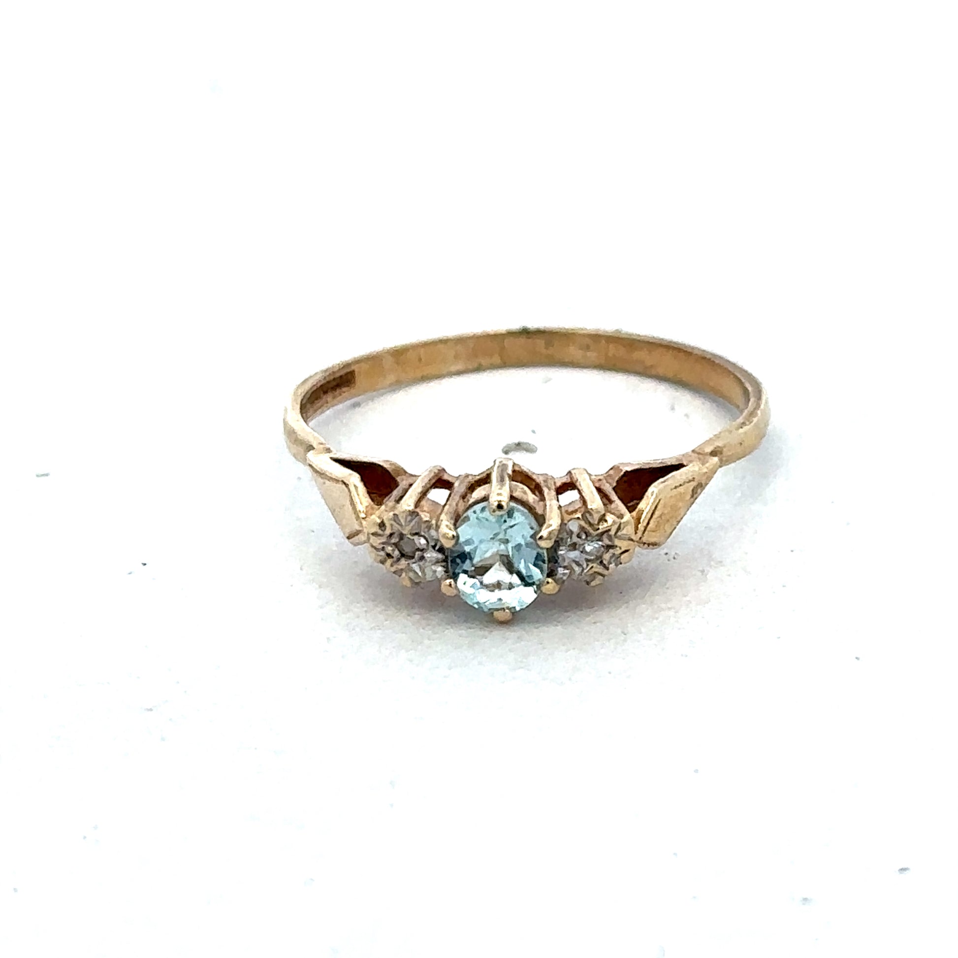 9ct yellow gold diamond ring by Reeves and Sons, showcasing a sparkling diamond set in a classic band design.