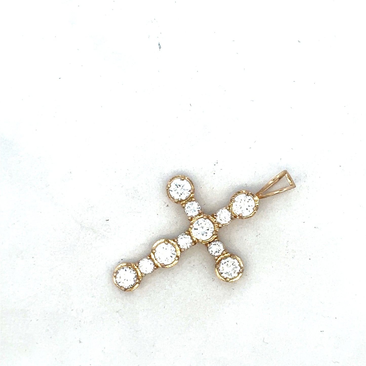 9ct yellow gold cross pendant from Reeves and Sons, featuring a detailed religious symbol design.