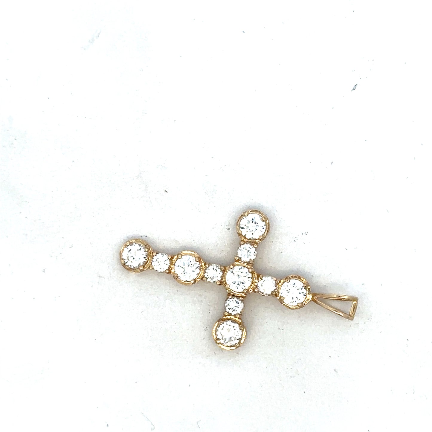 9ct yellow gold cross pendant by Reeves and Sons, showcasing a detailed religious jewelry design on a plain background.
