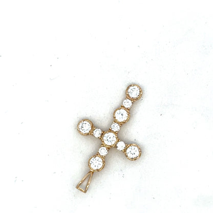 9ct yellow gold cross pendant by Reeves and Sons, featuring a detailed religious symbol, on a plain background.