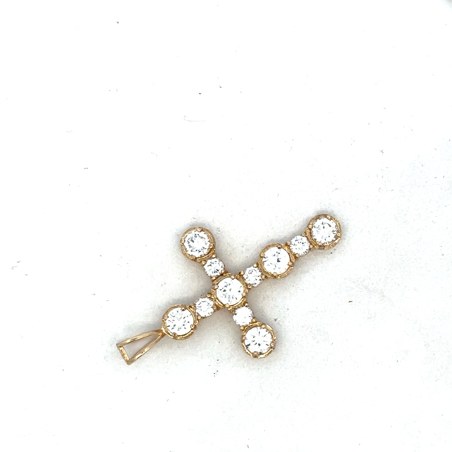 9ct yellow gold cross pendant by Reeves and Sons, showcasing a detailed religious jewelry design.