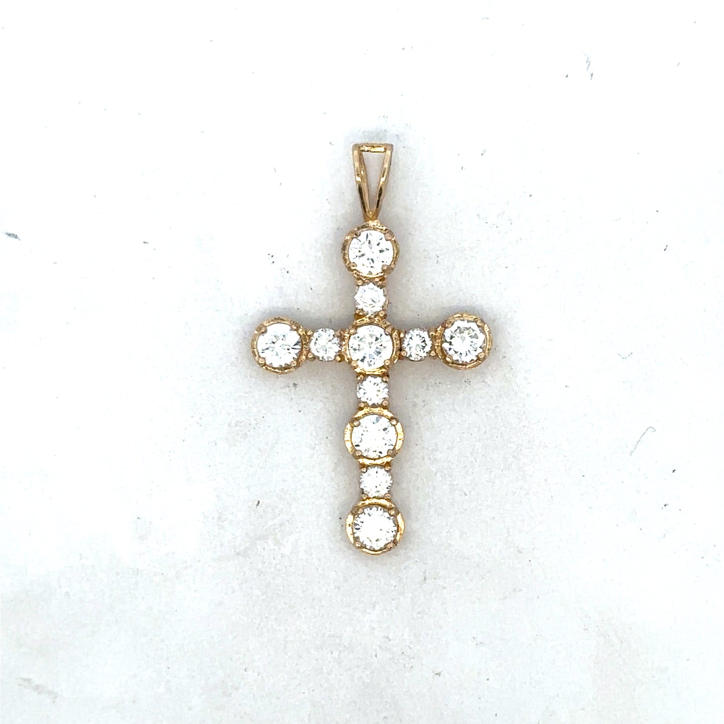 9ct yellow gold cross pendant by Reeves and Sons, featuring a detailed religious symbol with polished finish.