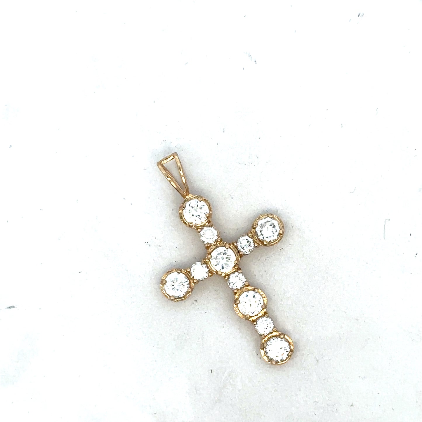 9ct yellow gold cross pendant by Reeves and Sons, showcasing a detailed religious jewelry design with polished finish.