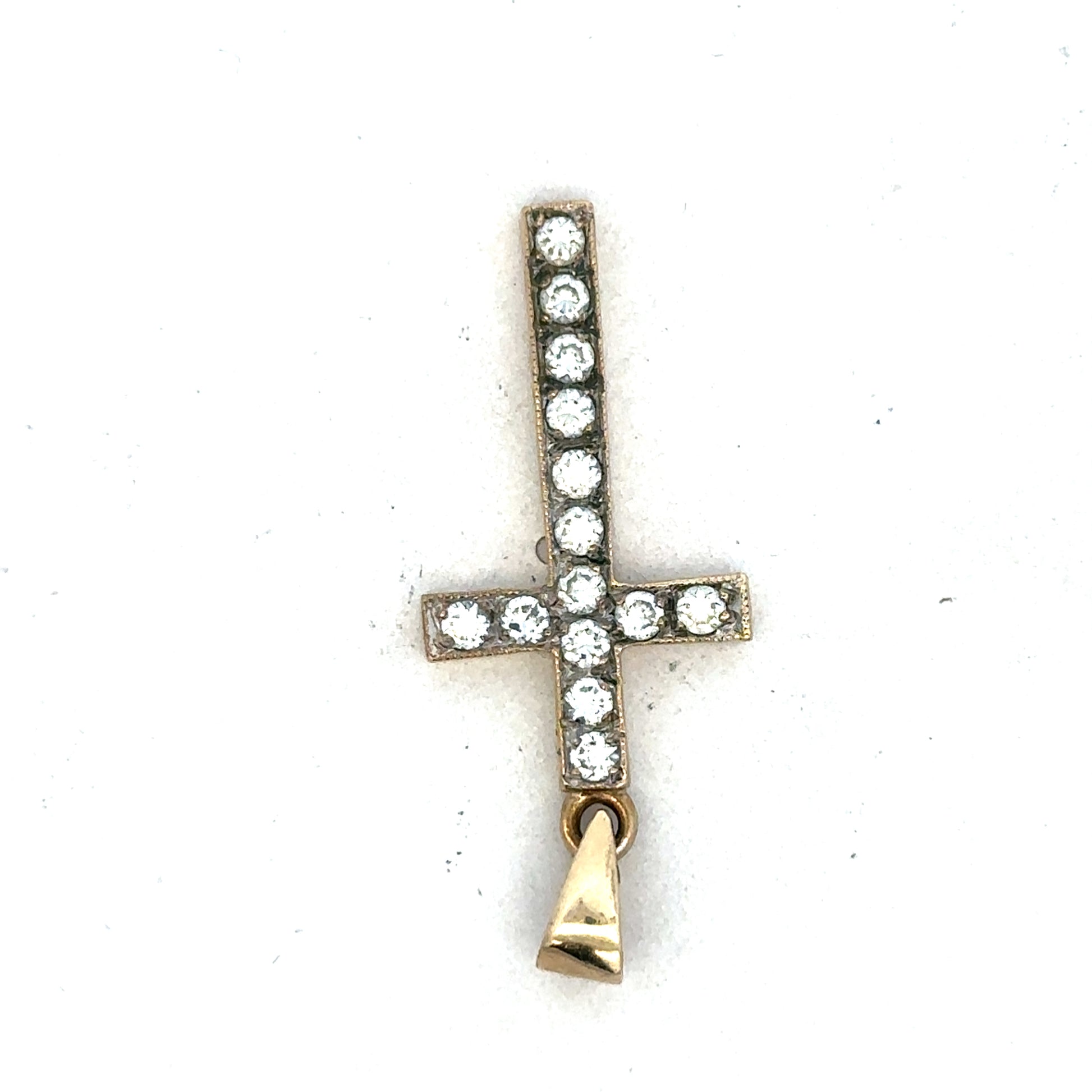 9ct yellow gold cross pendant from Reeves and Sons, showcasing a detailed religious jewelry design on a white background.