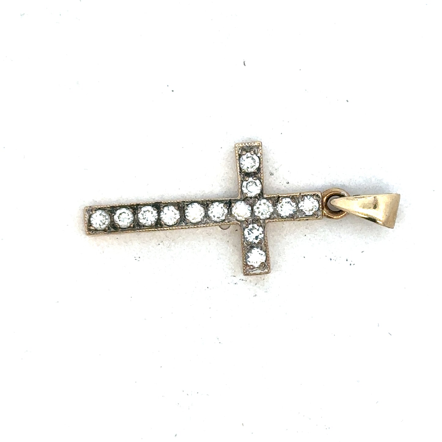 9ct yellow gold cross pendant by Reeves and Sons, featuring a detailed religious design, displayed on a plain background