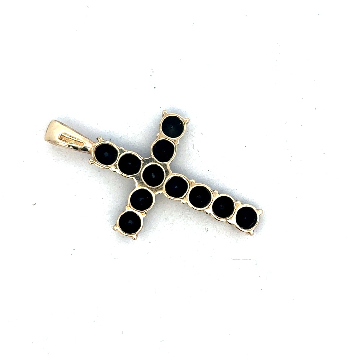 9ct yellow gold cross pendant by Reeves and Sons, showcasing a detailed religious jewelry design on a white background.