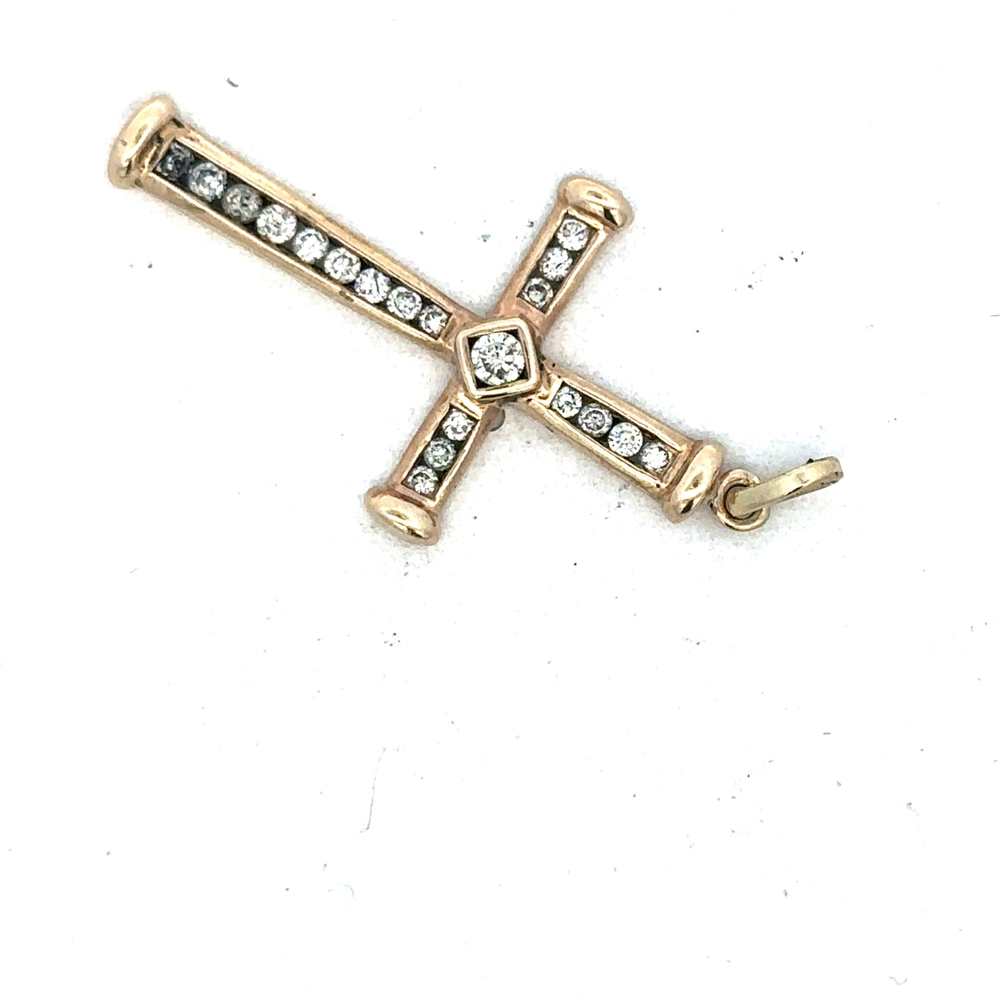 9ct yellow gold diamond cross pendant by Reeves and Sons, featuring a detailed cross design with sparkling diamonds.