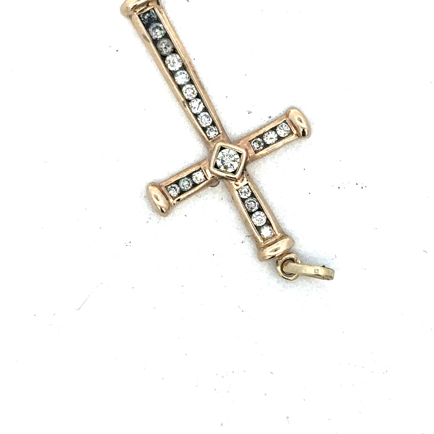 9ct yellow gold diamond cross pendant by Reeves and Sons, showcasing a detailed gold cross with sparkling diamonds.