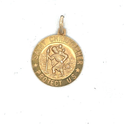 9ct yellow gold St Christopher pendant by Reeves and Sons, showing intricate religious design on a polished gold surface.