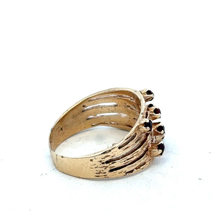 9ct yellow gold ring by Reeves and Sons featuring a smooth band and classic design, shown in close-up detail.