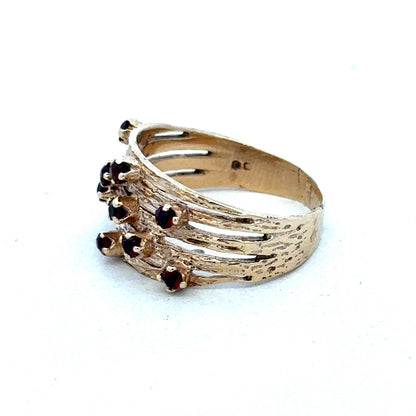 9ct yellow gold ring with a smooth polished band, crafted by Reeves and Sons, shown close-up with detailed surface.