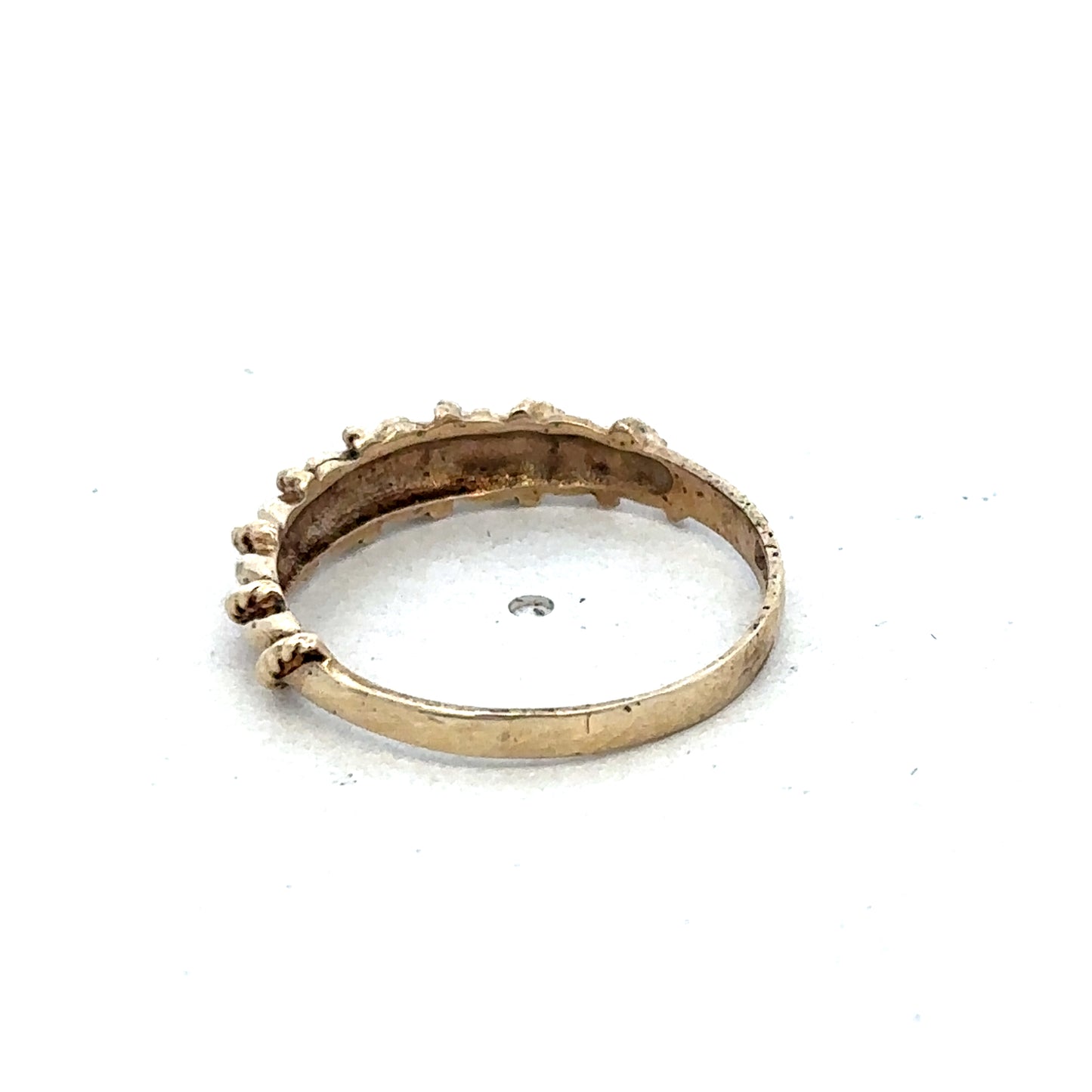 9ct yellow gold ring in size K by Reeves and Sons, featuring a smooth polished band with subtle design details.