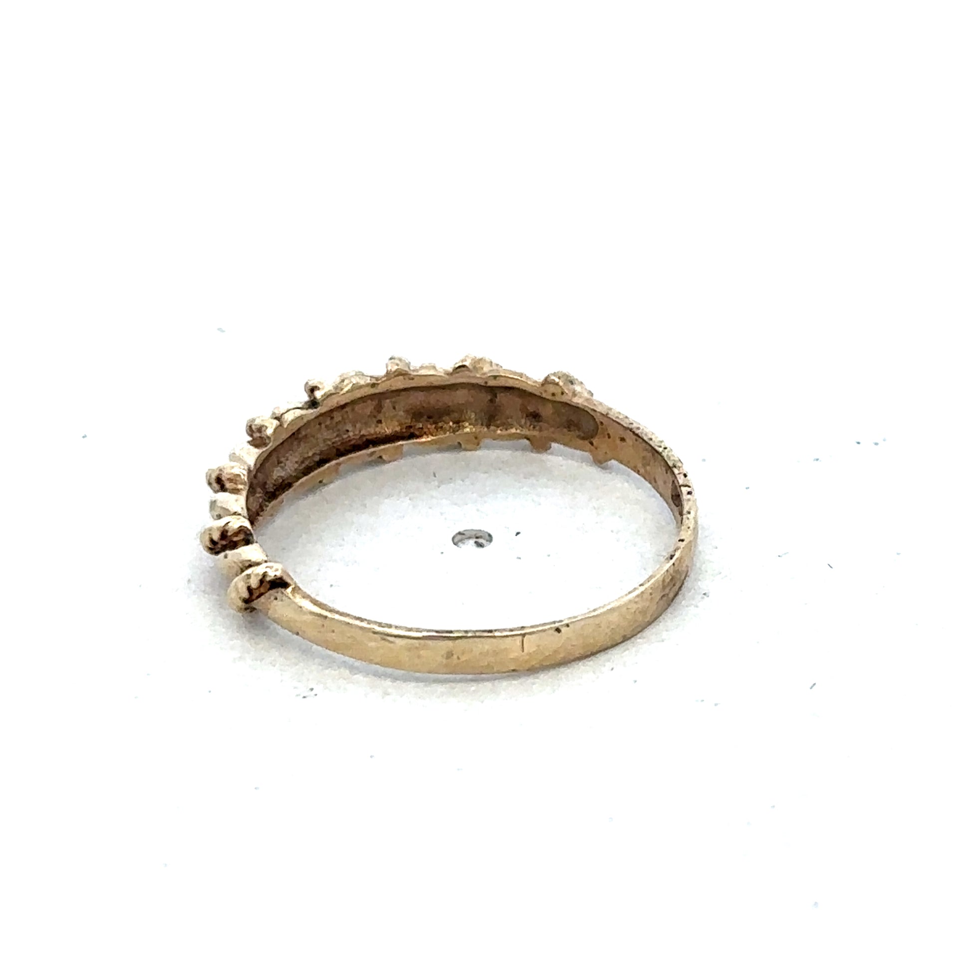9ct yellow gold ring in size K by Reeves and Sons, featuring a smooth polished band with subtle design details.