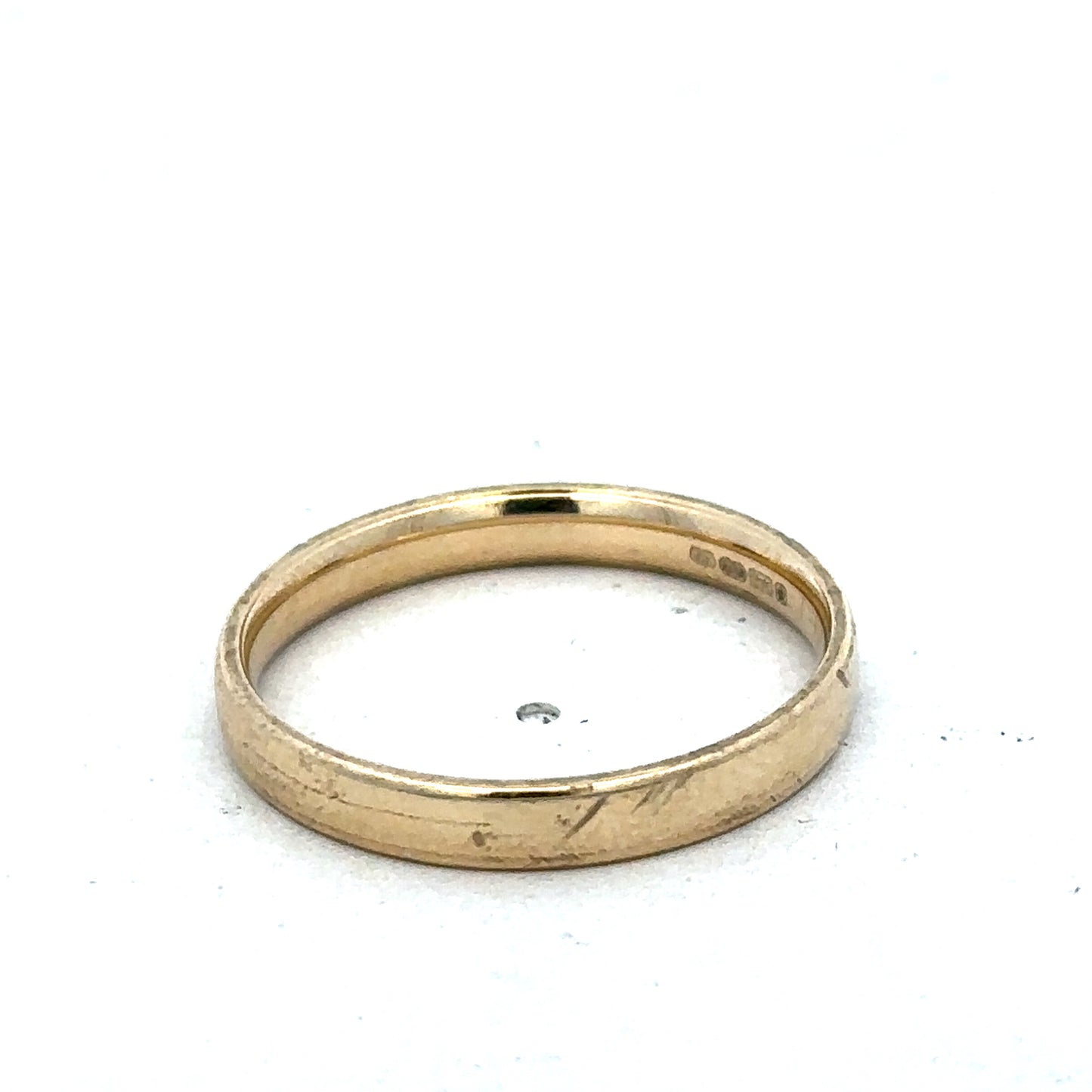 9ct yellow gold ring size T by Reeves and Sons, close-up showing smooth polished band and elegant design.