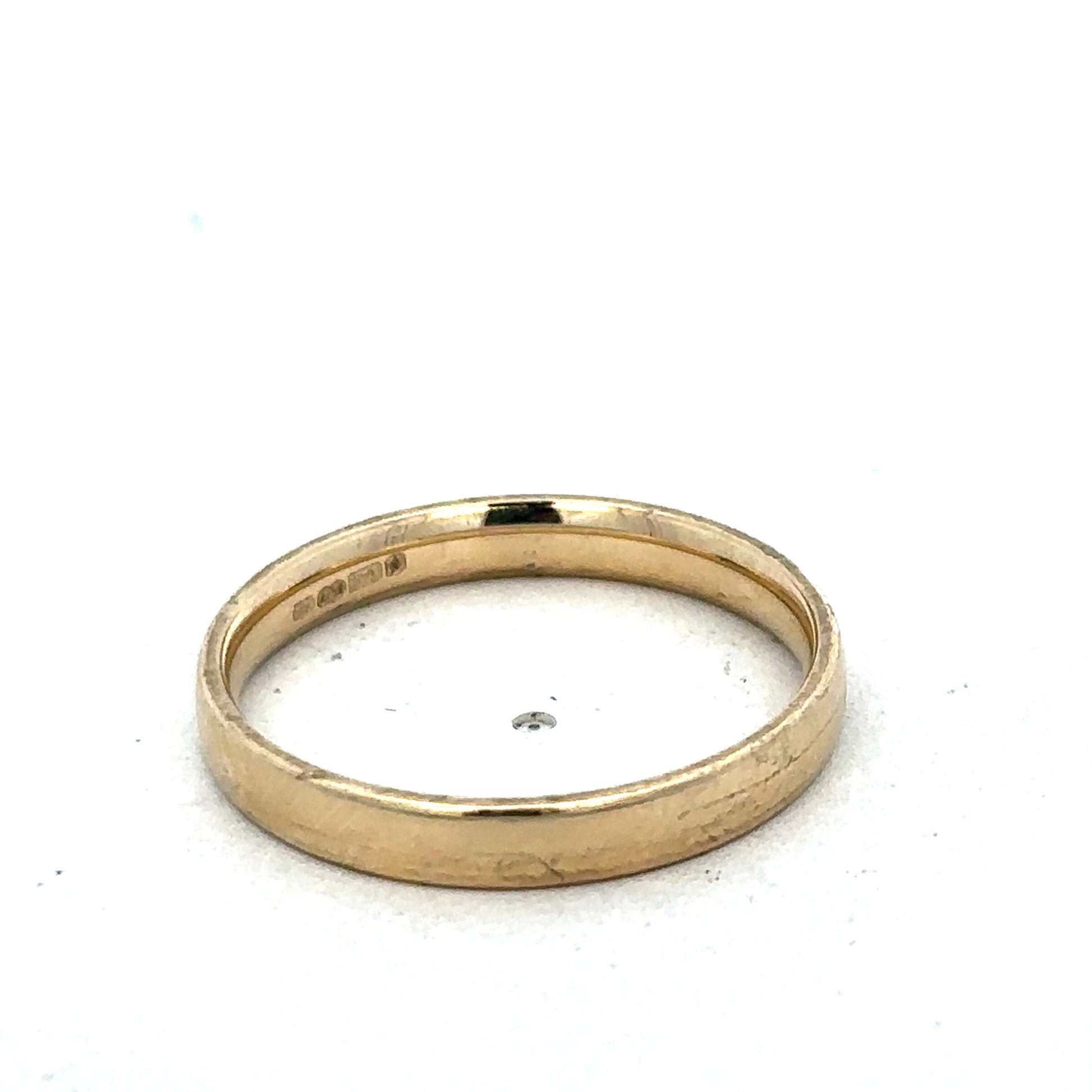 9ct yellow gold ring in size T with a smooth band, crafted by Reeves and Sons, shown on a plain background