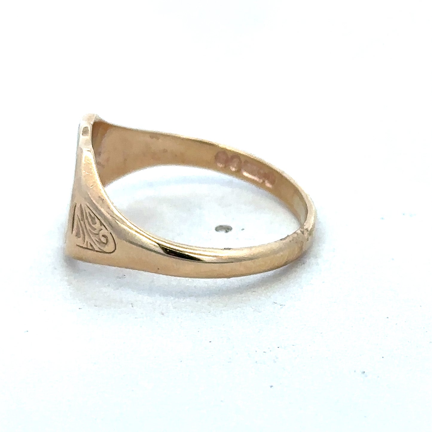 9ct yellow gold signet ring in size T with engraved face, crafted by Reeves and Sons, shown close-up on a plain background.
