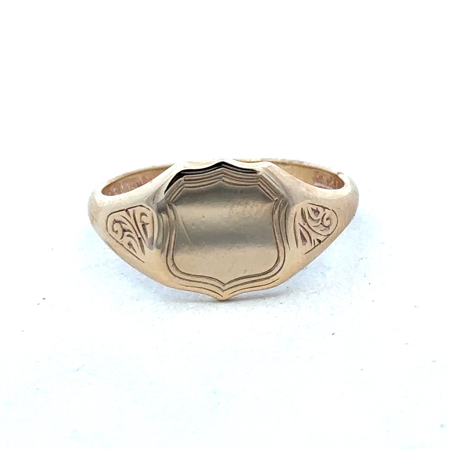 9ct yellow gold signet ring in size T with engraved face, crafted by Reeves and Sons, displayed on a neutral background.