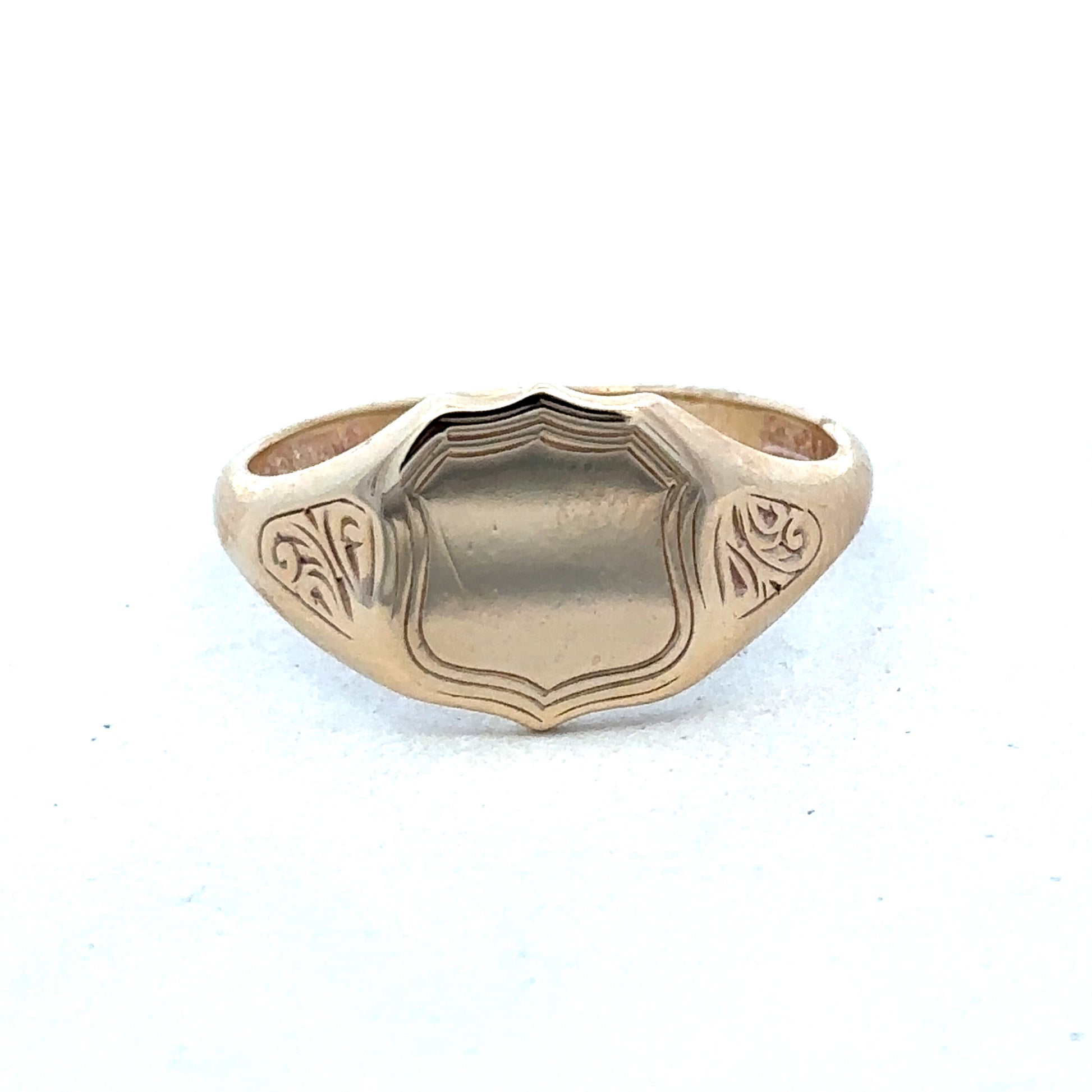 9ct yellow gold signet ring in size T with engraved face, crafted by Reeves and Sons, displayed on a neutral background.