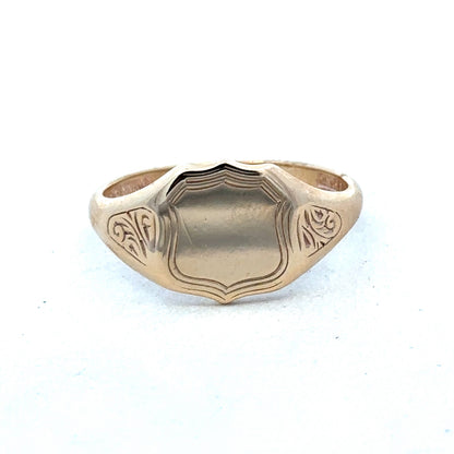 9ct yellow gold signet ring in size T with engraved face, crafted by Reeves and Sons, displayed on a neutral background.