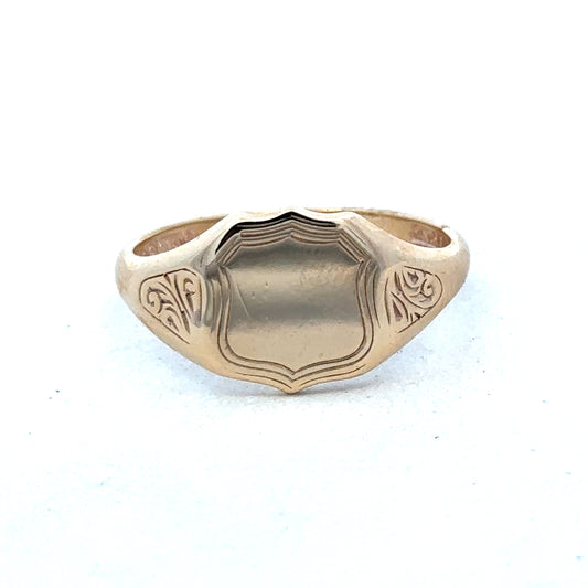 9ct yellow gold signet ring in size T with engraved face, crafted by Reeves and Sons, displayed on a neutral background.