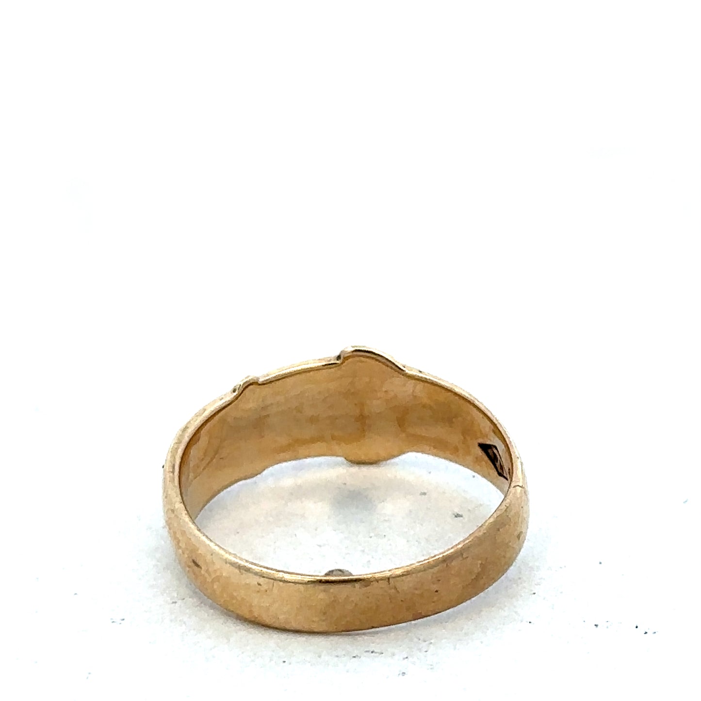 9ct yellow gold buckle ring in size L1/2 with textured design, crafted by Reeves and Sons, shown close-up.