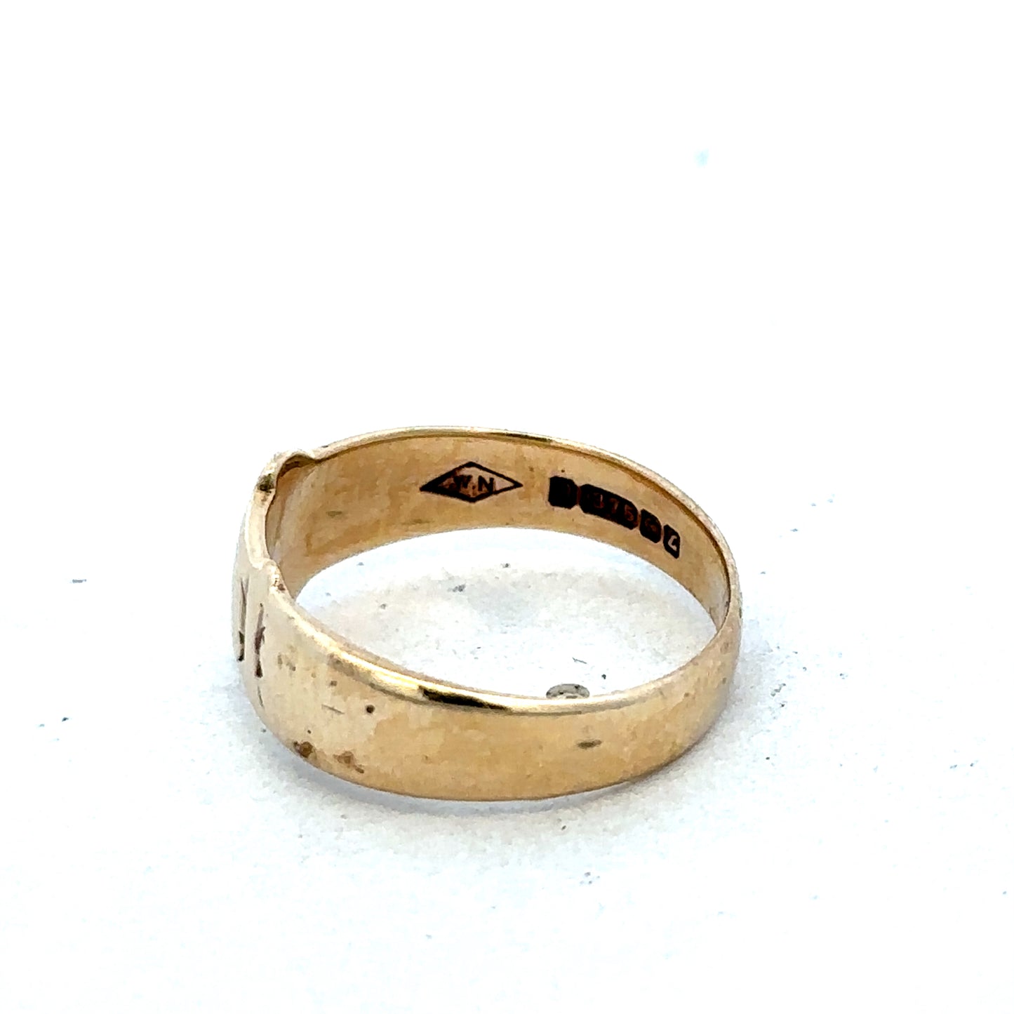 9ct yellow gold buckle ring in size L1/2, featuring a polished finish and adjustable design, by Reeves and Sons.