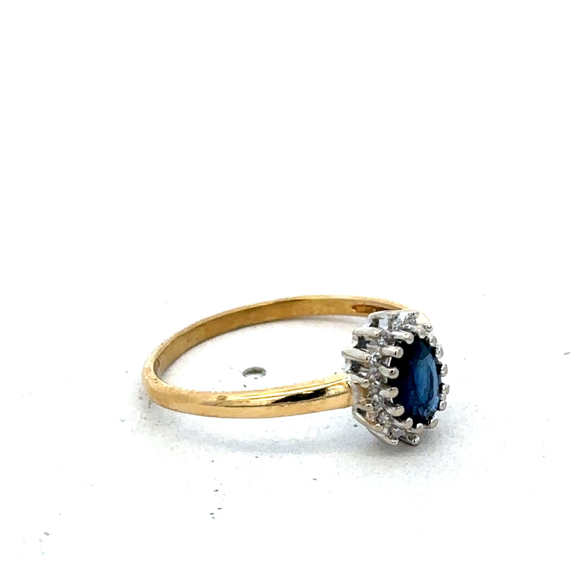 18ct yellow gold sapphire and diamond ring in size L1/2 by Reeves and Sons, featuring a central sapphire with diamond accents.