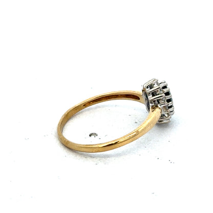 18ct yellow gold sapphire and diamond ring by Reeves and Sons, size L1/2, featuring a polished band and sparkling gemstones.